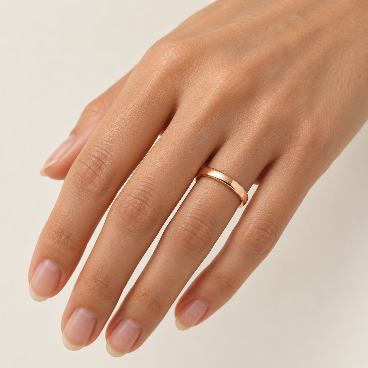 BASTION 3 mm — woman wearing an 18K rose gold wedding band, AI model illustration