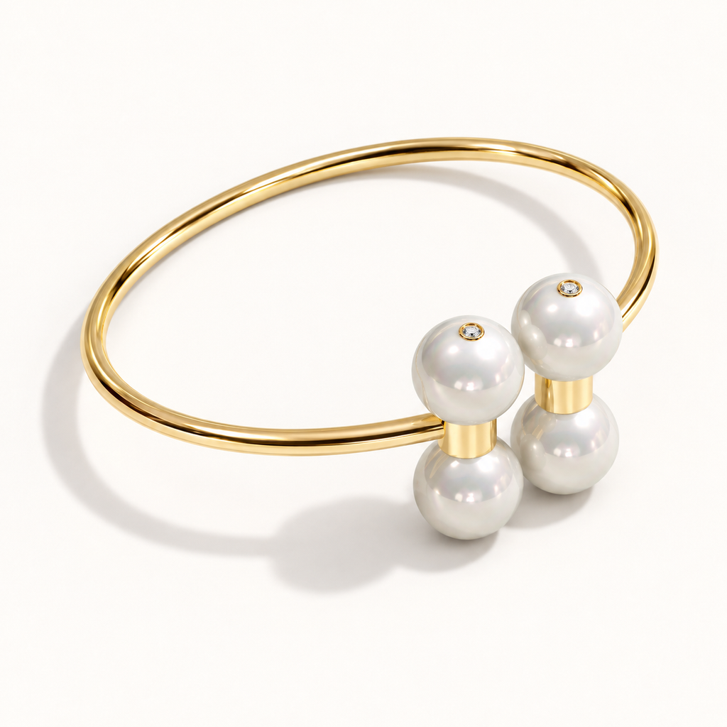 Barbelle Couple Bangle in 18K yellow gold with South Sea pearls and 0.01 ct bezel-set diamond accents — angle view