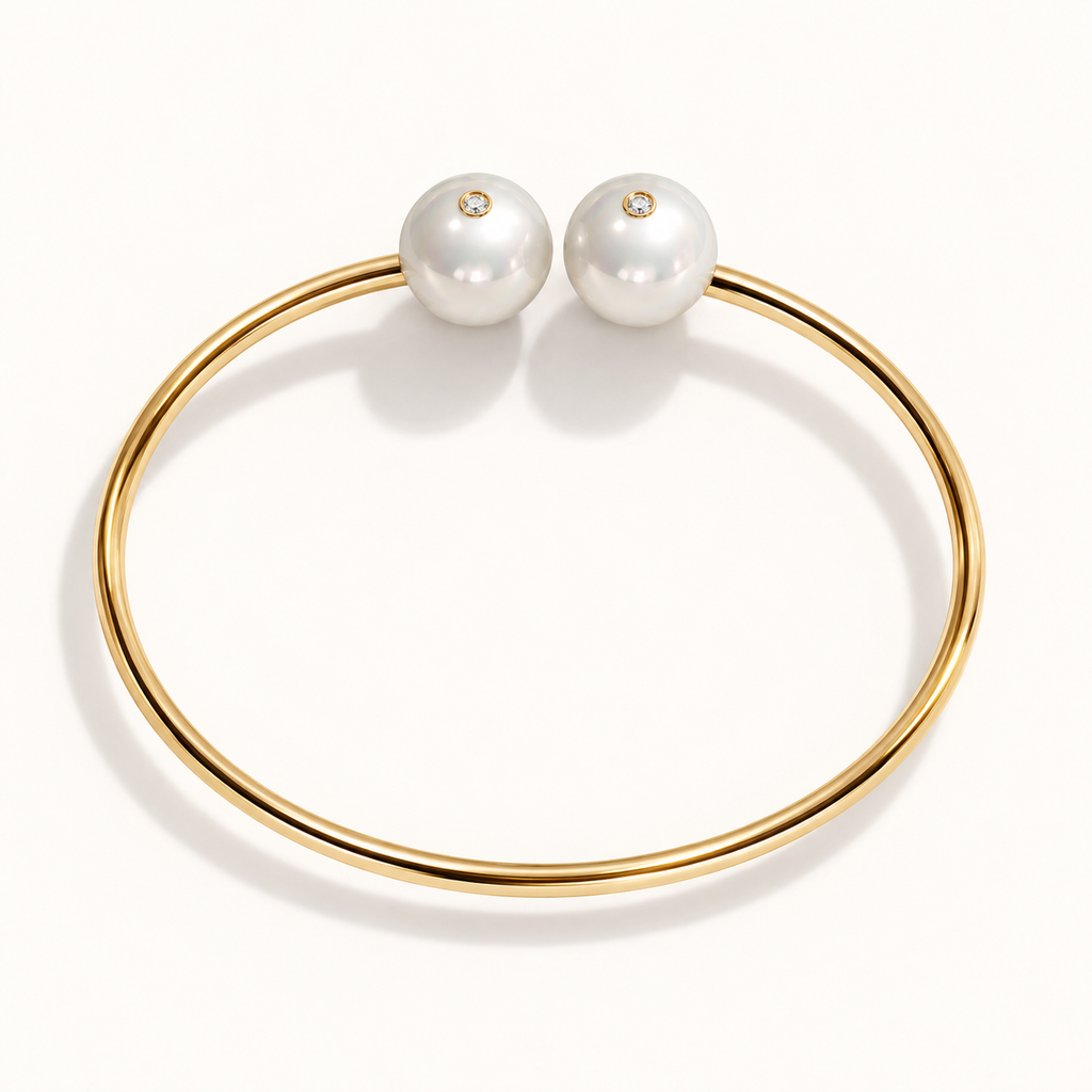 Barbelle Couple Bangle in 18K yellow gold with South Sea pearls and 0.01 ct bezel-set diamond accents — top view